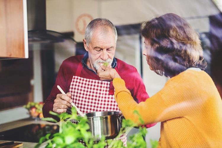 Senior couple preparing food in the kitchen.